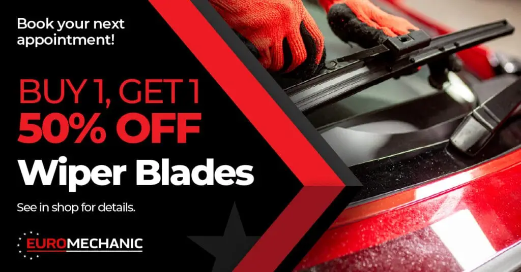 Close-up of gloved hands replacing a windshield wiper blade on a red car. Text promotes a Buy 1, Get 1 50% Off Wiper Blades offer at EuroMechanic, your trusted Auto Repair Guelph shop—book your appointment today. EuroMechanic - Brock Road Garage | Top Reviewed Auto Repair Shop in Guelph | Visit EuroMechanic - Brock Road Garage